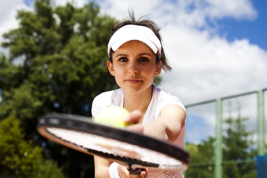 Girl playing tennis on the court