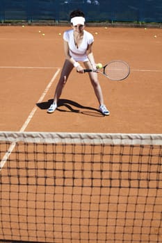 Girl playing tennis on the court