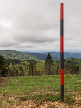 Striped pole along a path on top of the vogezen hills in France