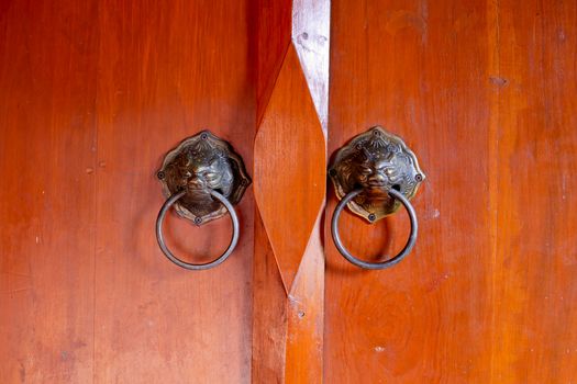 Old chinese door with lion's head door handles