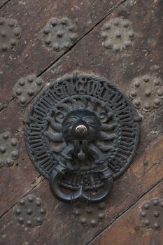 antique bell on massive wooden middle ages door