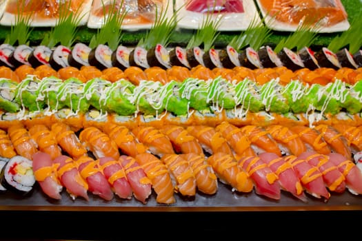Japanese Cuisine -Buffet catering style Sushi Set in restaurant - salmon Maki Sushi and Nigiri Sushi