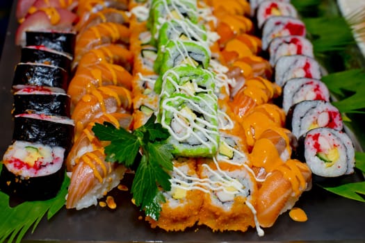 Japanese Cuisine -Buffet catering style Sushi Set in restaurant - salmon Maki Sushi and Nigiri Sushi