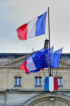 group of French flags in front of building