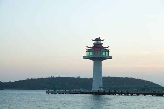 Lighthouse tower. Pier compared coast of the island. In the morning