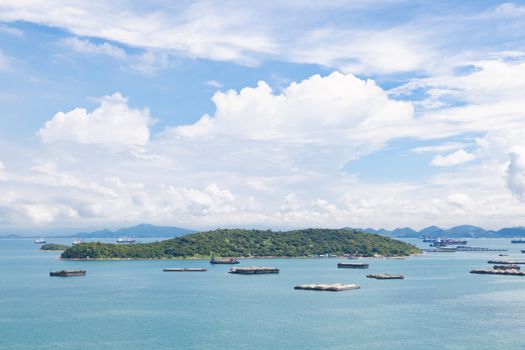 Cargo ships in the sea Waiting to dock. Mostly clear skies.