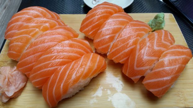 Japanese cuisine. Set of sushi nigiri on wooden plate