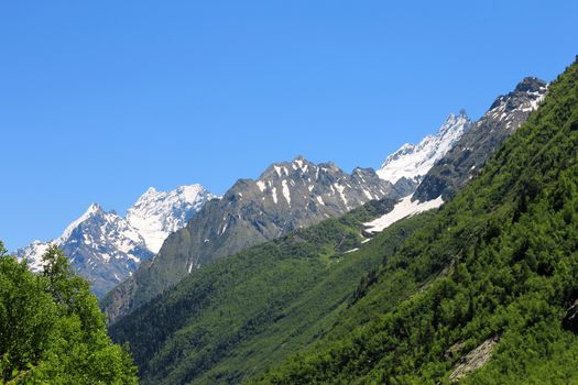 Caucasus Mountains Under Snow And Clear Blue Sky