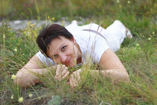 Woman laying in the grass on the meadow