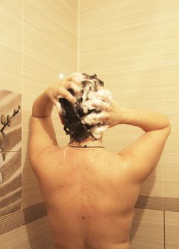 Adult woman washing her hair in the shower