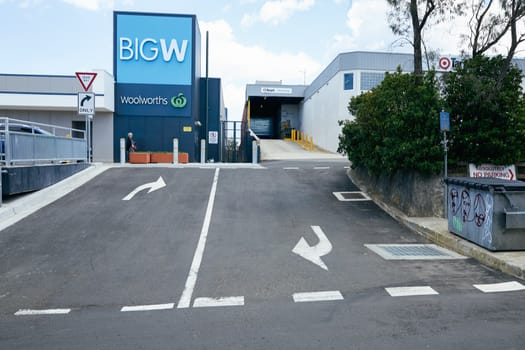Pedestrian walking under Big W sign at the new shopping centre in Katoomba, Blue Mountains, Australia