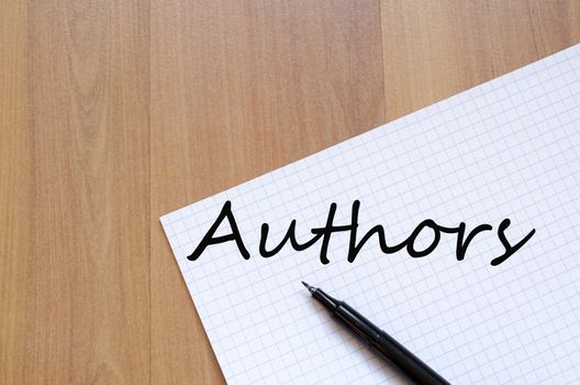 White blank notepad on office wooden table Authors concept