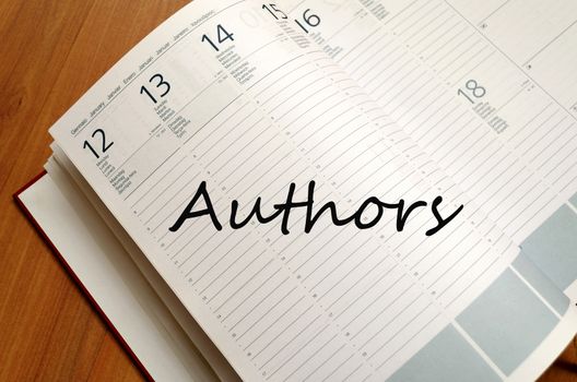 Business Notepad on wooden table Authors concept