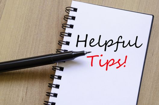 White notepad and ink pen on the wooden desk Helpful tips concept