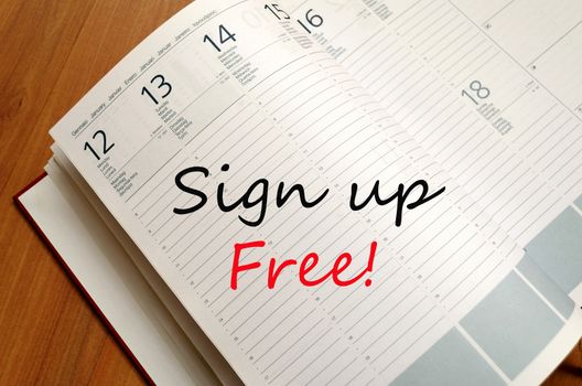 Business Notepad on wooden table Sign up free concept