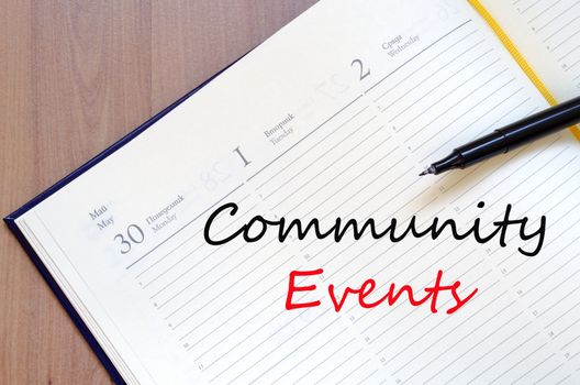 Yellow blank notepad on office wooden table Community events concept