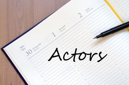 Yellow blank notepad on office wooden table Actors concept