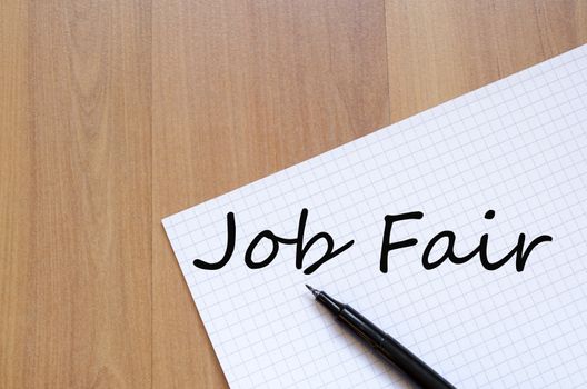 White blank notepad on office wooden table Job fair concept