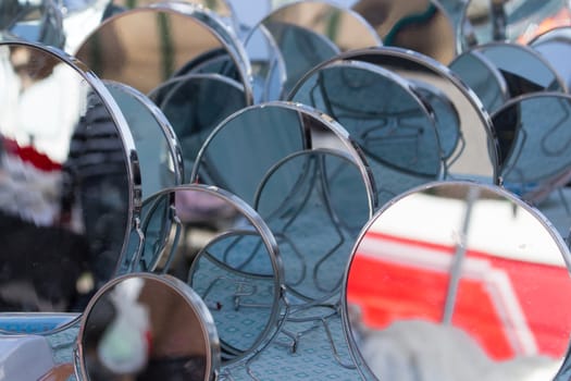 a multitude of mirrors posing in a market