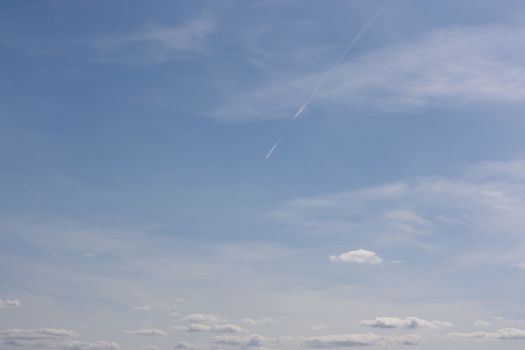 Smalll white clouds set against a blue sky