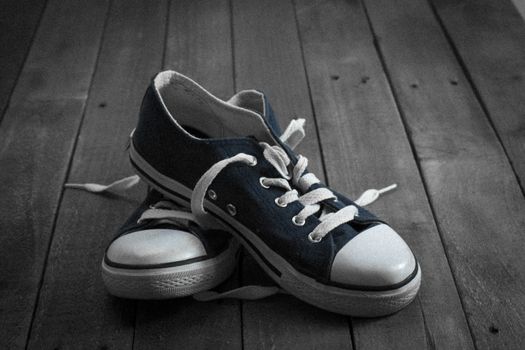 Old worn shoes left on a wooden floor