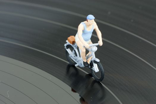 Model people having a cycle race on a record
