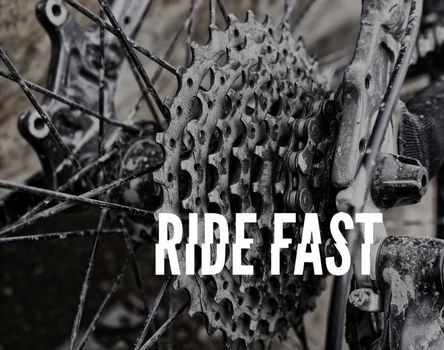 Photograph of a bicycle stars, gears and chain, with the words: RIDE FAST in white capital letters