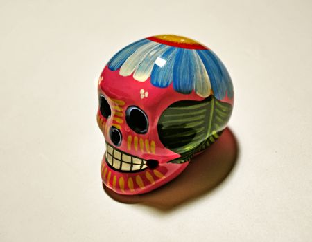 Photograph of a ceramic skull with flowers, representing deads day mexican celebration