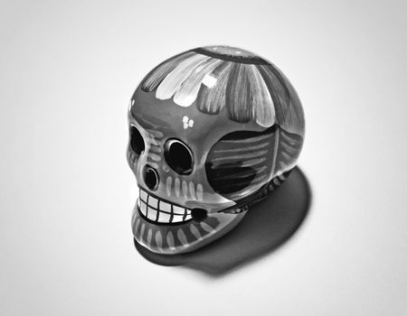 Photograph of a ceramic skull with flowers, representing deads day mexican celebration