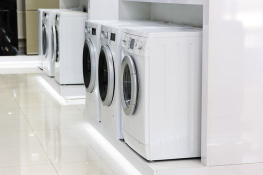 Row of washing machines in big appliance store