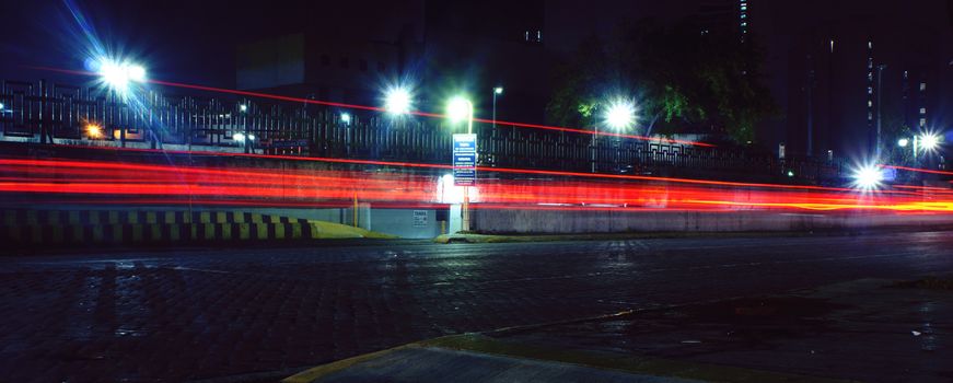 Photograph of some urban car blured lights on a night scene