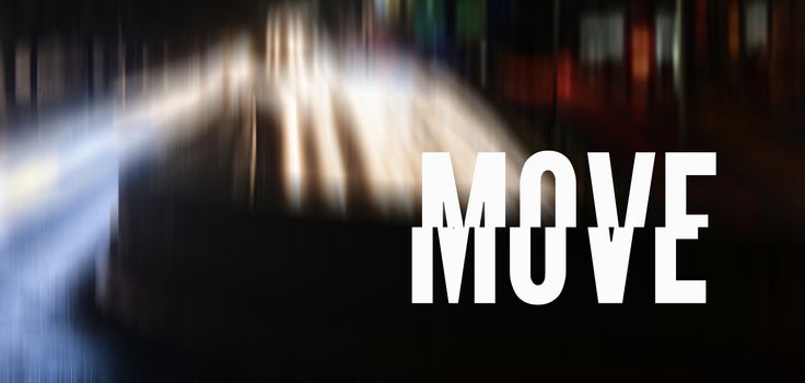 Photo of a street with car lights and the word MOVE in white and capital letters