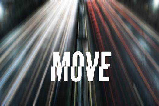 Photo of a street with car lights and the word MOVE in white and capital letters