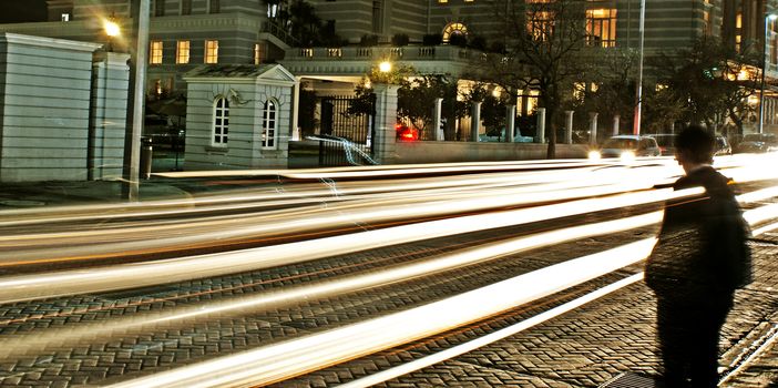 Photograph of some urban car blured lights on a night scene