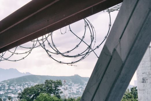 Photograph of a barb wire on a cloudy sky