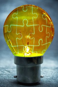 Jigsaw puzzle solution inside a light bulb