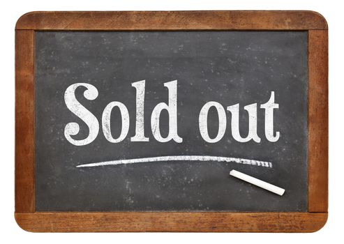 Sold out sign  - white chalk text on an isolated  vintage slate blackboard
