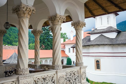 Church inside Sambata de Sus Monastery seen trough a colonade in Transylvania, Romania