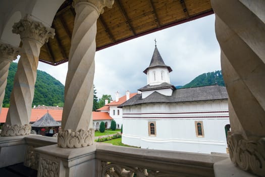 Church inside Sambata de Sus Monastery seen trough a colonade in Transylvania, Romania
