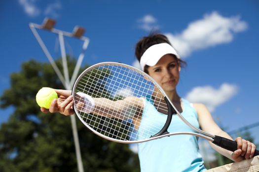 Woman playing tennis in summer