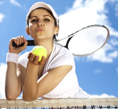 Young woman tennis player on the court