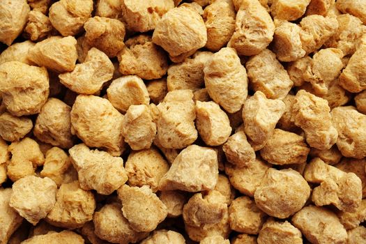 Soya protein chunks used in vegetarian and vegan food as an abstract background texture