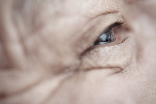 Close-up view on the eye of elderly human