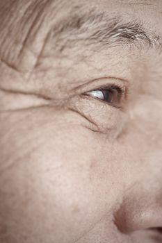 Face of elderly man looking away. Vertical photo