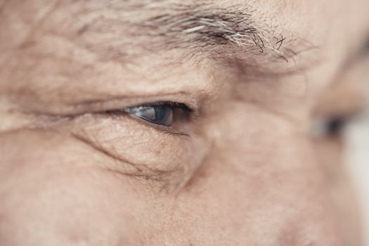 Close-up view on the eye of elderly human