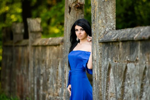 Portrait of sensual fashion young woman in blue dress outdoor