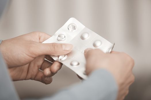 Hands of woman holding pack of medicament