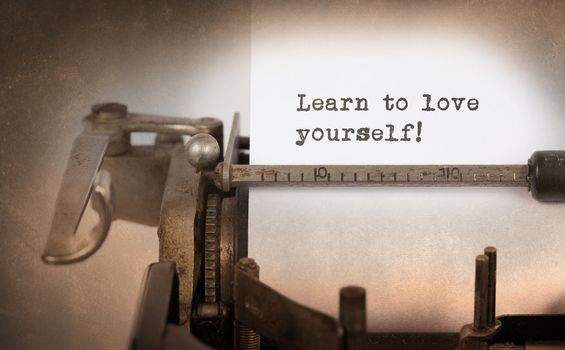 Vintage inscription made by old typewriter, Learn to love yourself