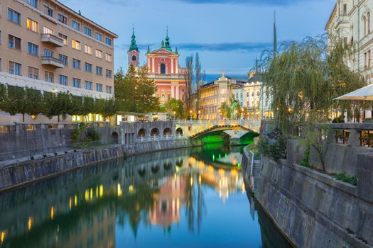 Romantic Ljubljana city center. River Ljubljanica, Triple Bridge - Tromostovje, Preseren square and Franciscan Church of the Annunciation. Ljubljana Slovenia Europe.