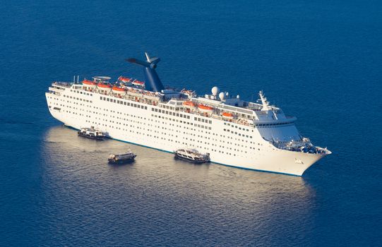 Luxury cruise ship sailing around Santorini island, Aegean sea in Greece.